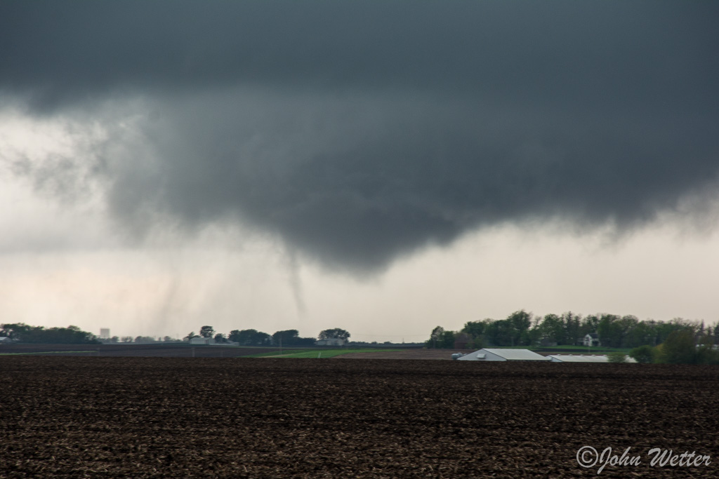 A large bowl lowered wall cloud was rapidly rotating with these finger funnels periodically rotating around the area.  After watching a bit, you could see the entire area had a circulation on the ground.